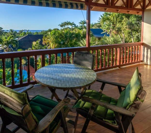 Private balcony seating overlooking tropical gardens and Muri Lagoon